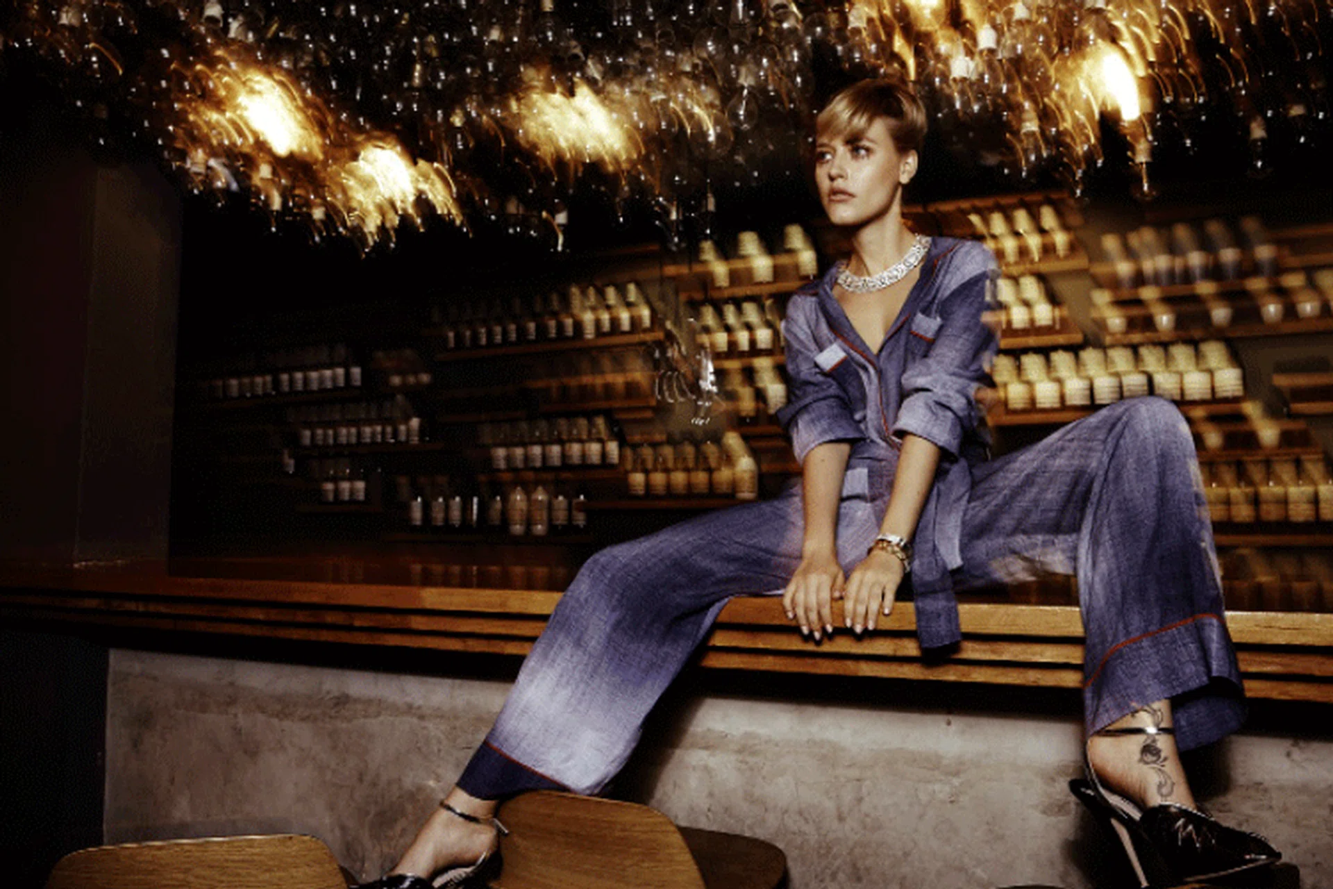 Viscose jumpsuit, Fendi. Dazzling metal necklace with crystals, matching bangle, and Distinctmetal bangle with crystals, Swarovski. Patent leather ankle-strap pumps, Miu Miu