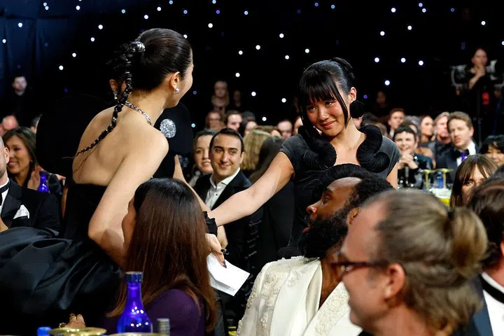 SANTA MONICA, CALIFORNIA - JANUARY 04: (L-R) EJAE and Rei Ami react to winning the Best Song Award for 'Golden' in the film "KPop Demon Hunters" during the 31st Annual Critics Choice Awards at Barker Hangar on January 04, 2026 in Santa Monica, California. (Photo by Kevin Mazur/Getty Images for Critics Choice Association)
