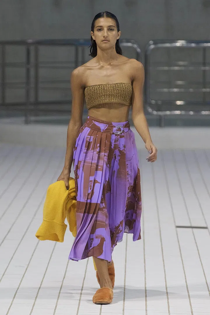 A model walking on runway wearing Rejina Pyo Spring Summer 2022 Women Ready to Wear Fashion Show on September 2021 in London, UK