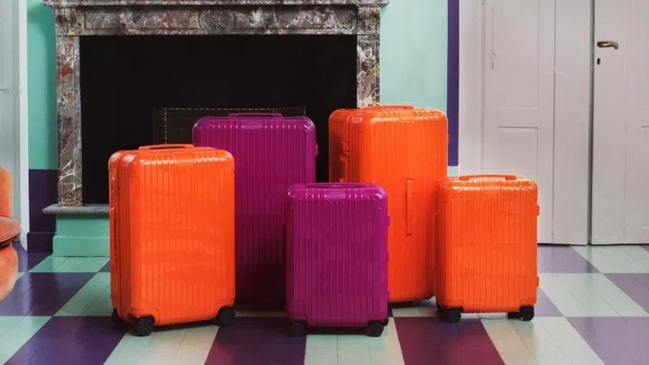 Rimowa orange and magenta luggage