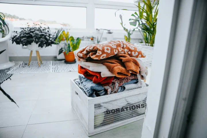 donations box full of clothes  for charity at the entrance of house