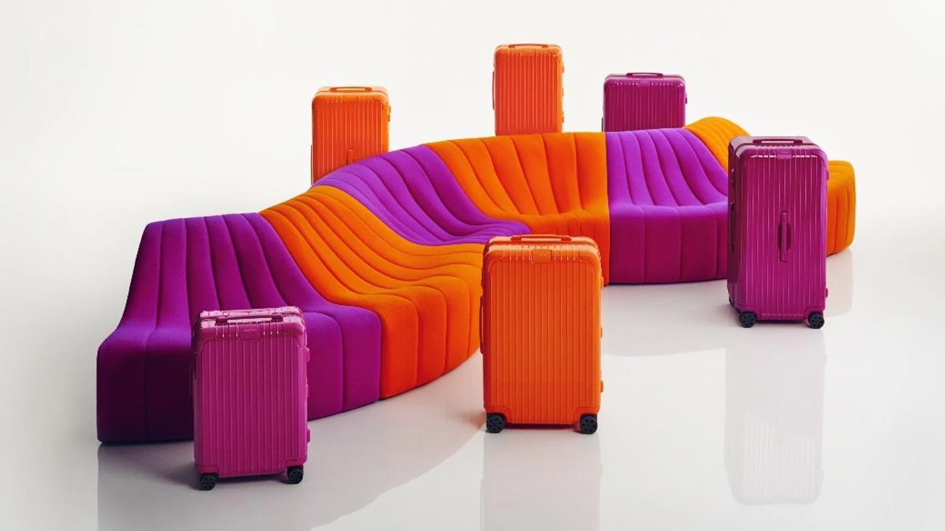 Rimowa orange and magenta luggage