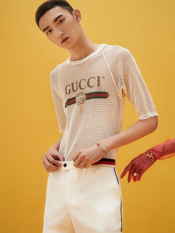 Cotton T-shirt and cotton-blend shorts, Gucci. Tiffany Victoria platinum necklace with diamonds, Hardwear Ball 18K yellow gold necklace, and matching sterling silver cuff, Tiffany & Co. 