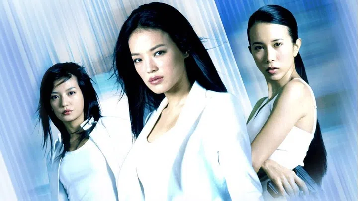 Action film still from So Close (2002) starring Shu Qi, Zhao Wei, and Karen Mok. The image highlights the iconic “fighting angels” aesthetic with the lead trio in tactical white clothing and a cinematic, high-motion backdrop.