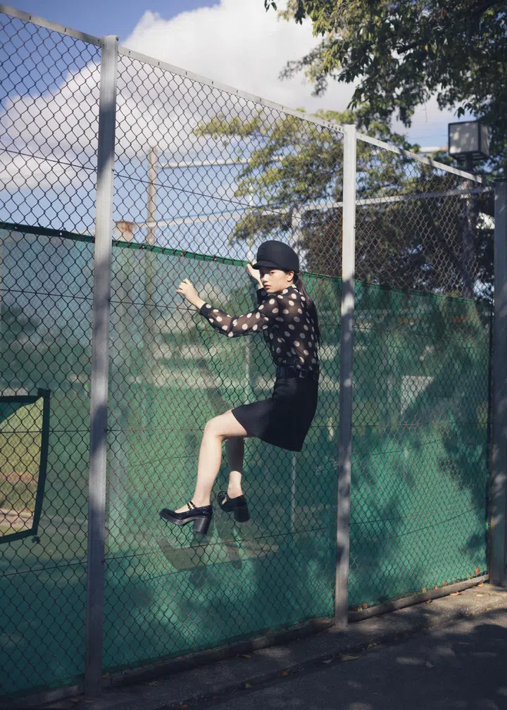 Japanese photographer Osamu Yokonami models climbing fence