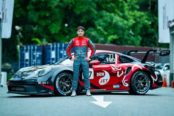 Danial Frost posing with his race car.
