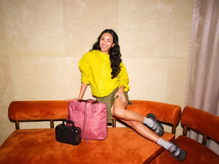Efy Ramdan, creative head of nightlife space Rasa, pictured with the Rimowa Signature Sliding tote bag in Granada pink