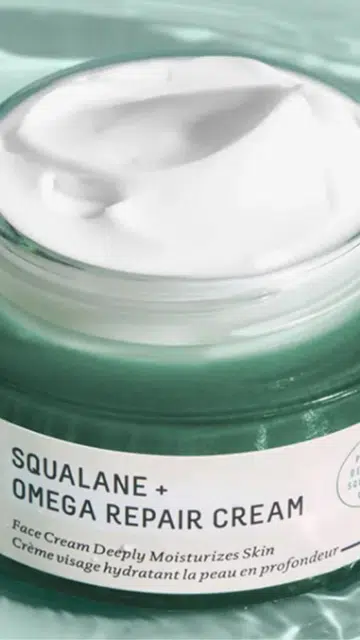 A model trying the Biossance Squalane cream