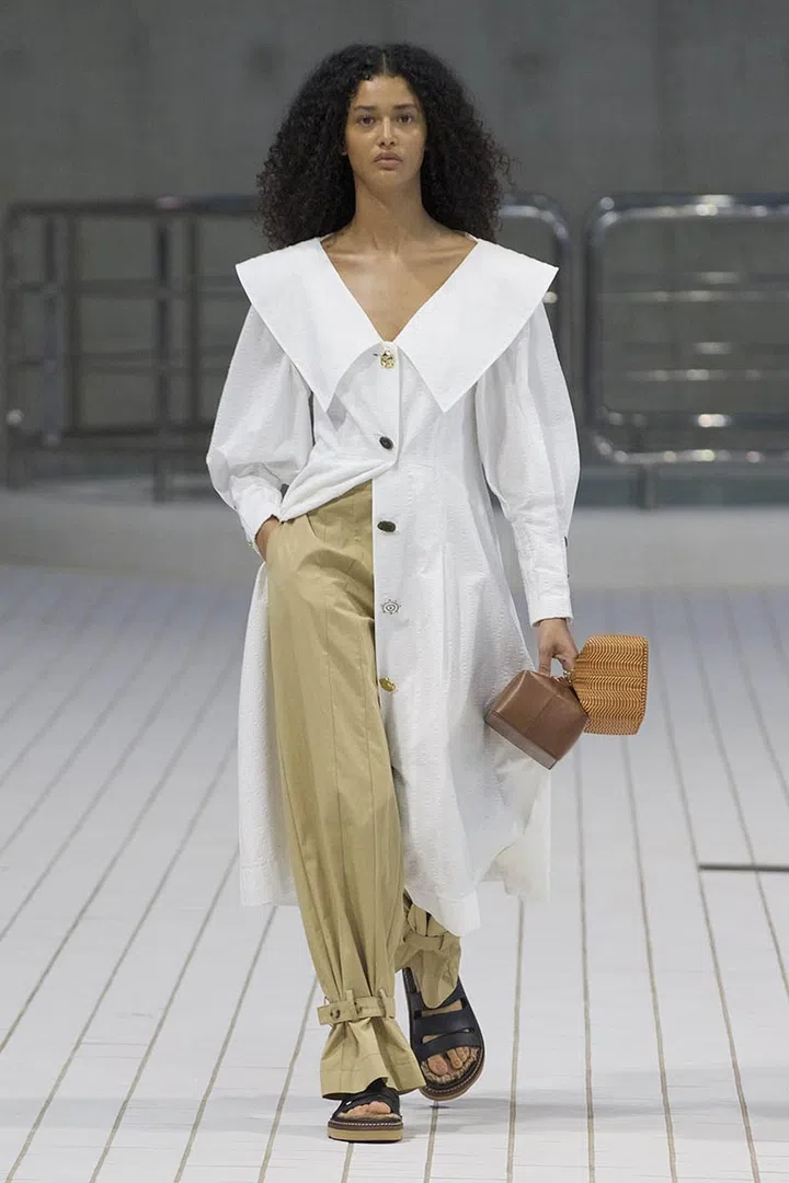 A model walking on runway wearing Rejina Pyo Spring Summer 2022 Women Ready to Wear Fashion Show on September 2021 in London, UK