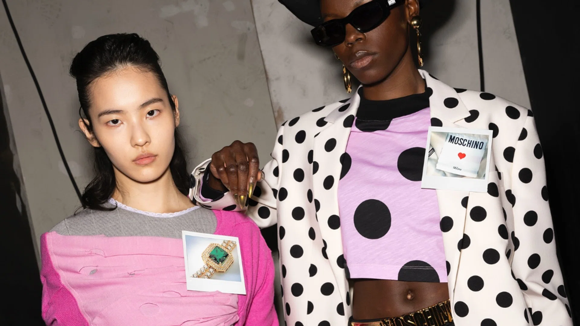 Models wearing Moschino outfits.