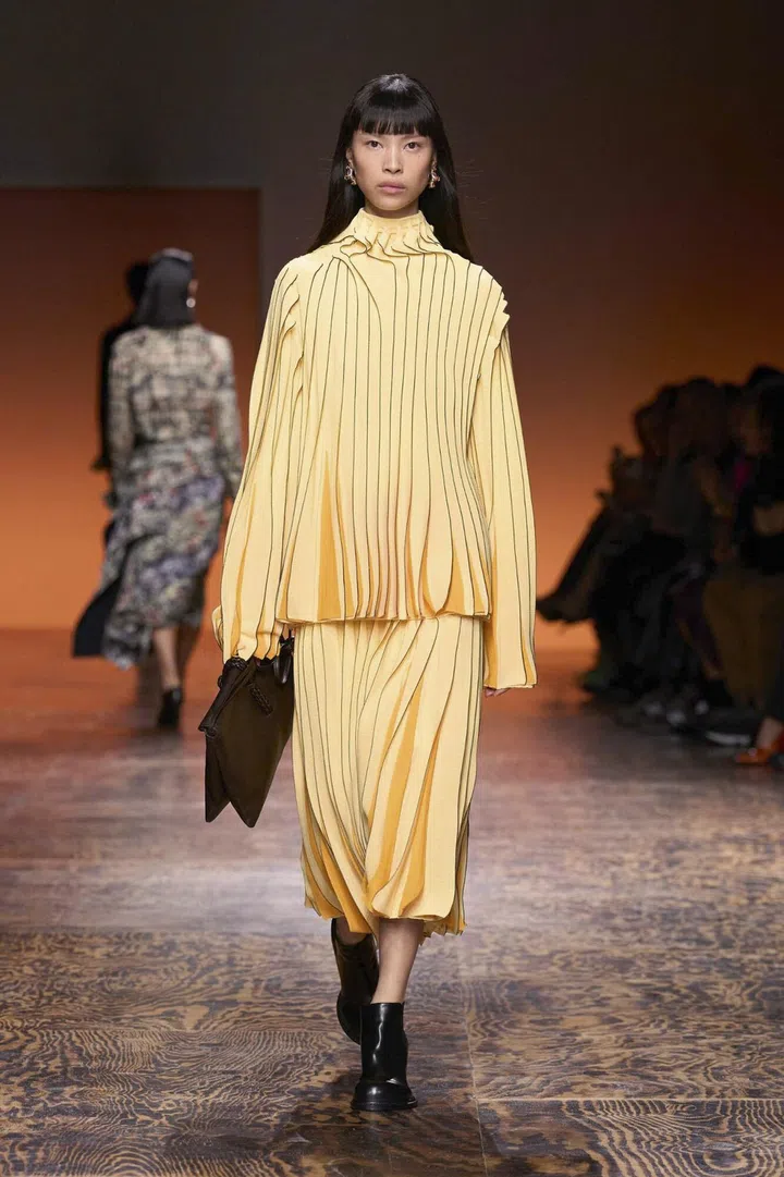 In this photo a model walks on the runway of a Fashion Show in Milan, Italy and wears a Bottega Veneta Women Ready to Wear Fall Winter 2024 outfit in February 2024 Fashion Week