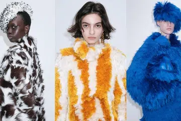 Models on the Bottega Veneta Fall Winter 2026 runway showcasing oversized shaggy faux fur coats in electric blue, orange-white patterns, and spotted brown-white textures with matching textured headwear.