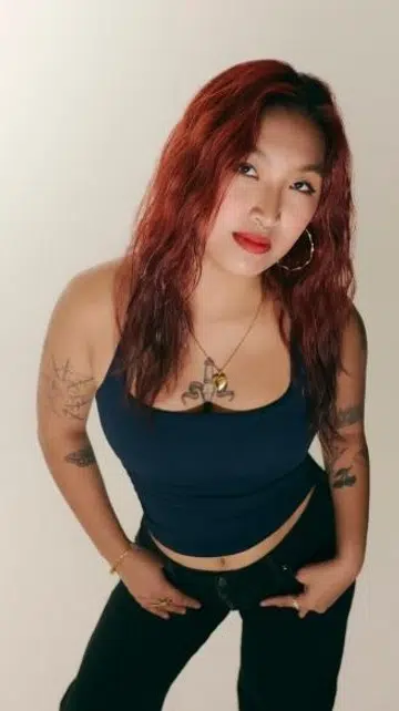 Bartender Erika Danielle for F ZINE Singapore, studio portrait with red hair and tattoos.