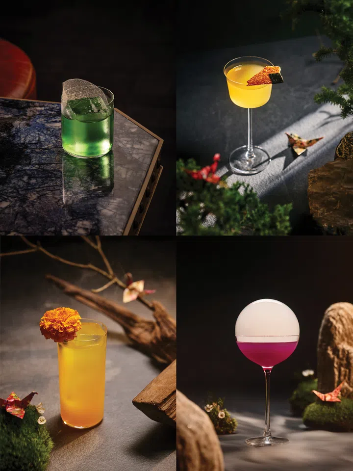 Japanese-inspired cocktails at Koma Marina Bay Sands, each with unique colours and garnishes, served in a stylish bar setting