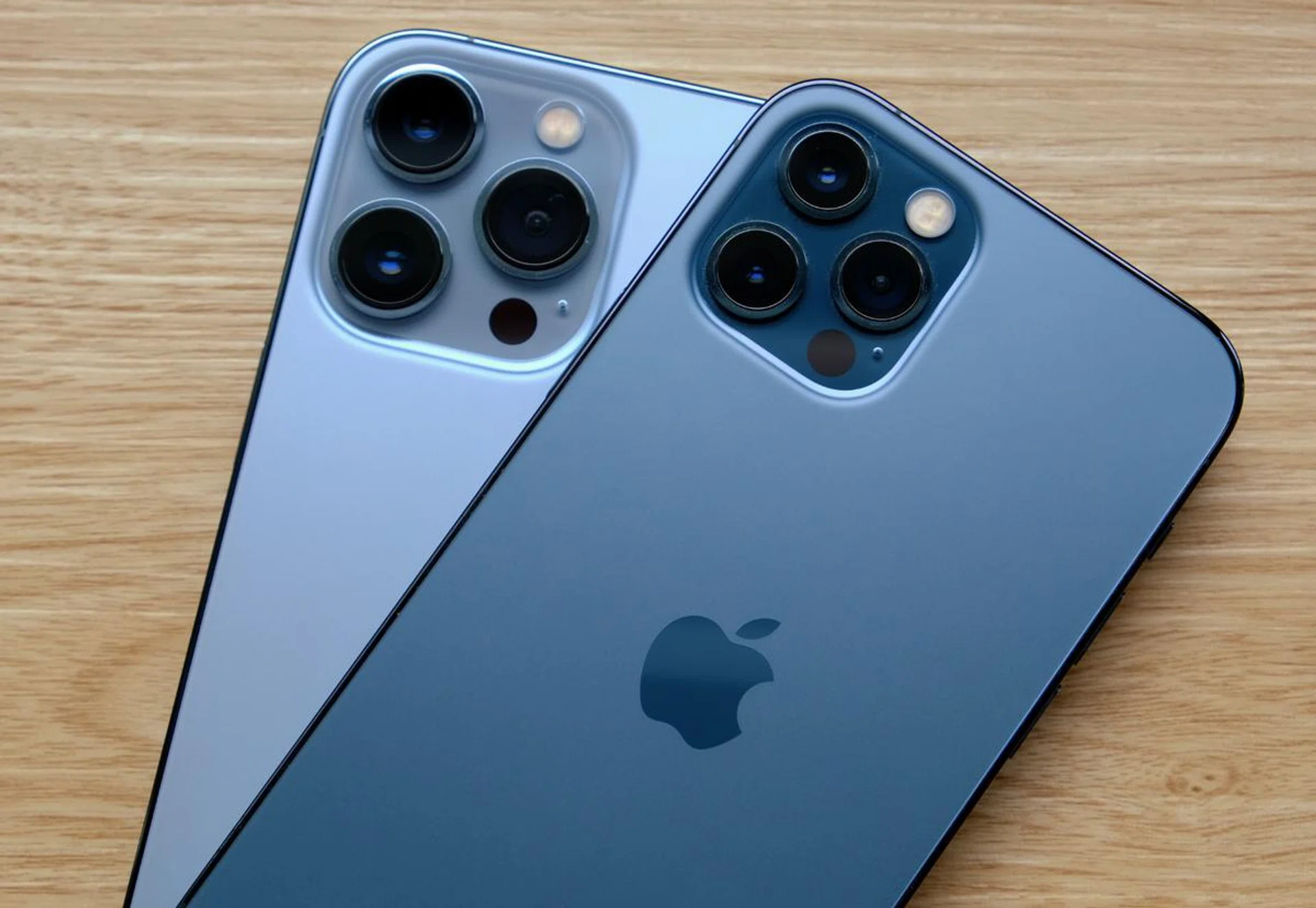The iPhone 13 Pro Max in Sierra Blue below and the iPhone 12 Pro in Pacific Blue above.