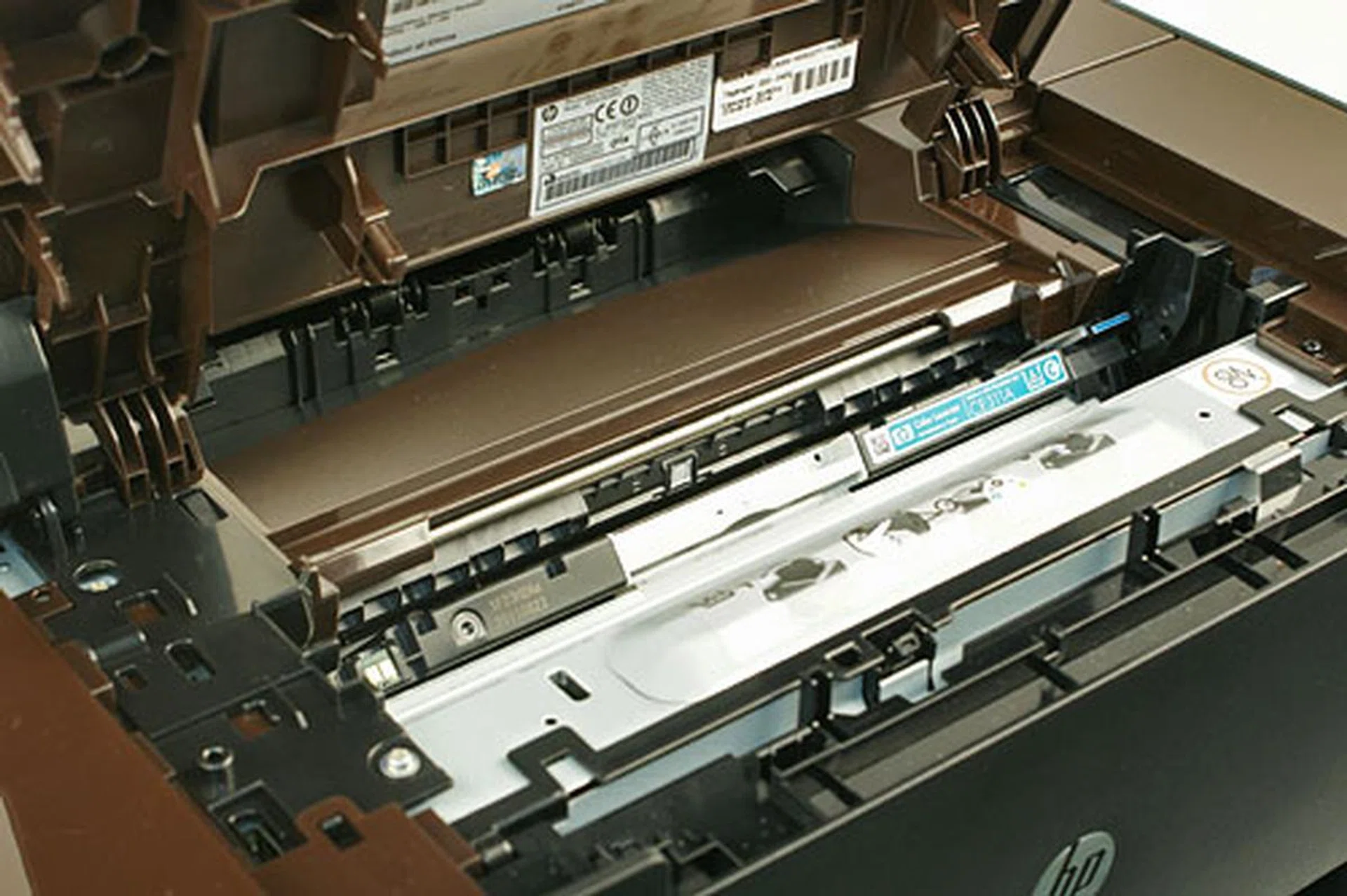 Below the capture stage is the toner cartridge compartment. If the cartridge at the opening isn't the one that you want to replace, you can go to the home screen of the control panel, navigate to the Supplies menu, and select Cartridge Rotate to turn the cartridge carousel.