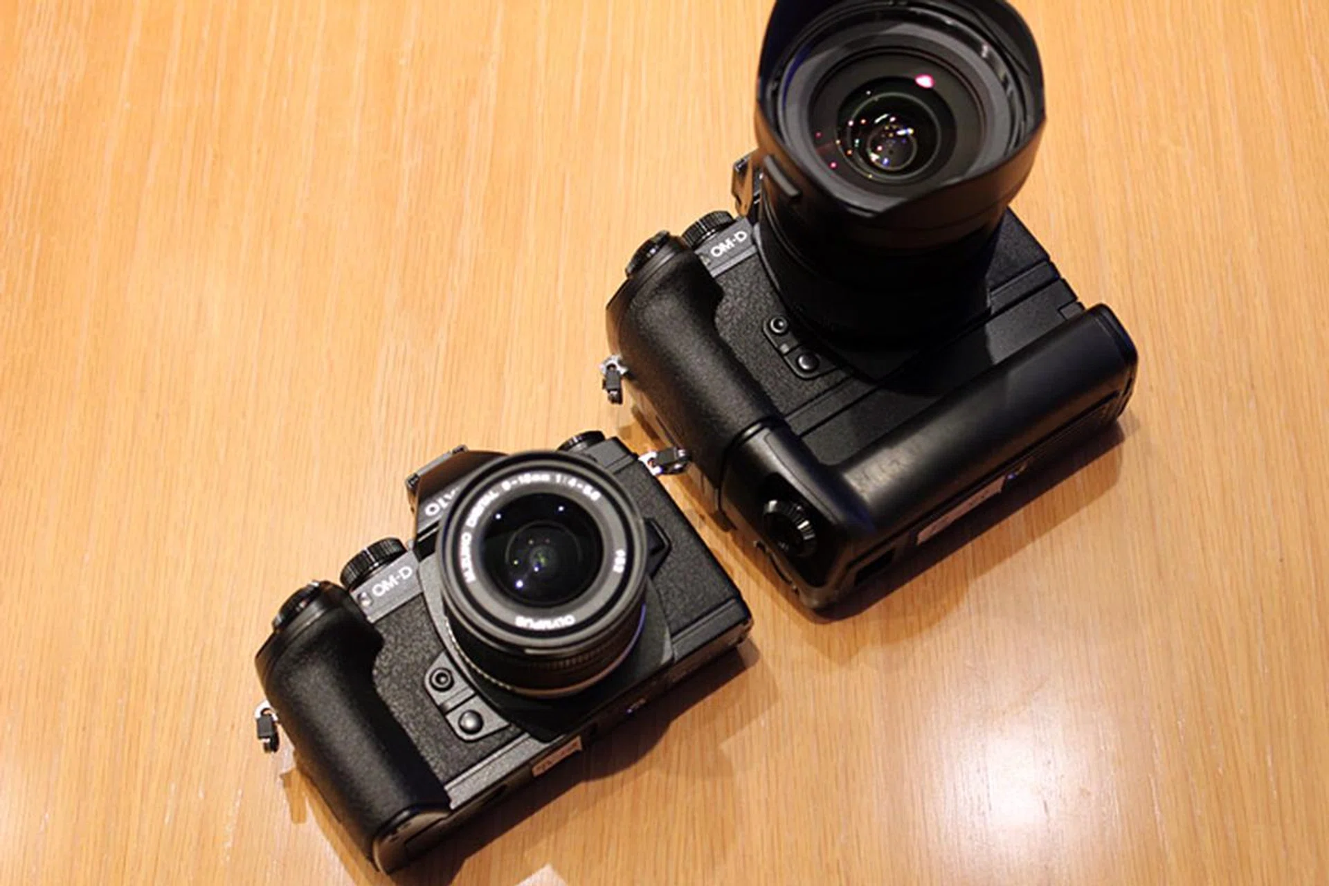 The E-M1 with a battery grip attached (right). It's a different model than the one used on the E-M5.