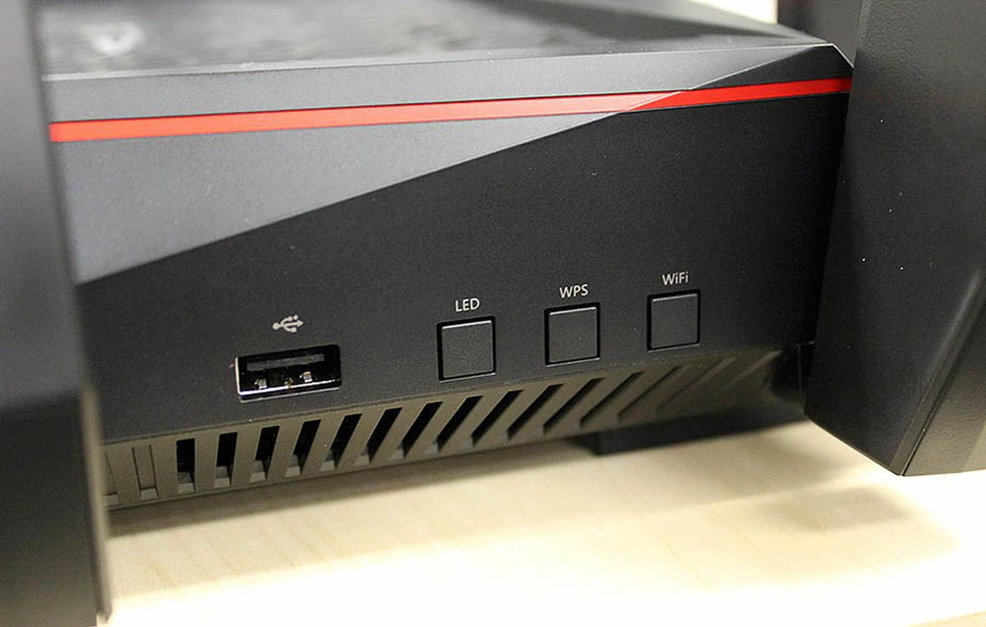 To the left is a USB 2.0 port and buttons for turning off the LED indicators and Wi-Fi. There's also a button for WPS setups.