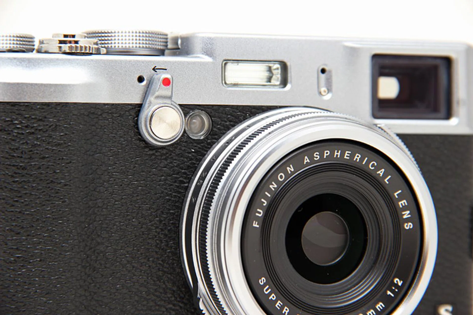 You switch between the optical and electronic viewfinders by flipping the viewfinder selector on the front of the camera.