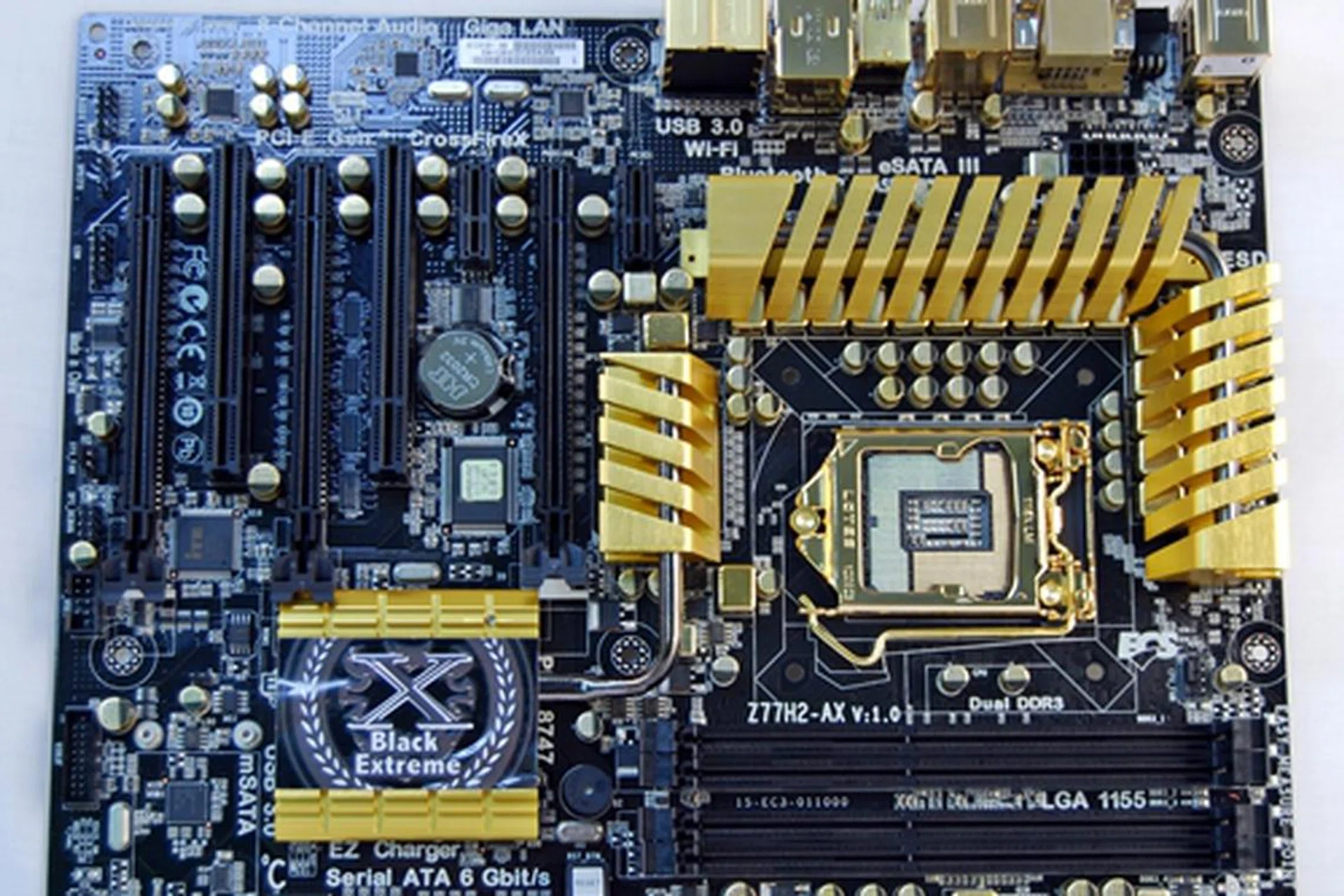 The ECS Z77H2-AX is an opulent looking board with gilded components set against a black PCB. Even its VRM heatsinks are gold-plated as well as its capacitors and chokes. Its CPU socket metal frame and the CPU back panel have also been given the gold colored treatment.