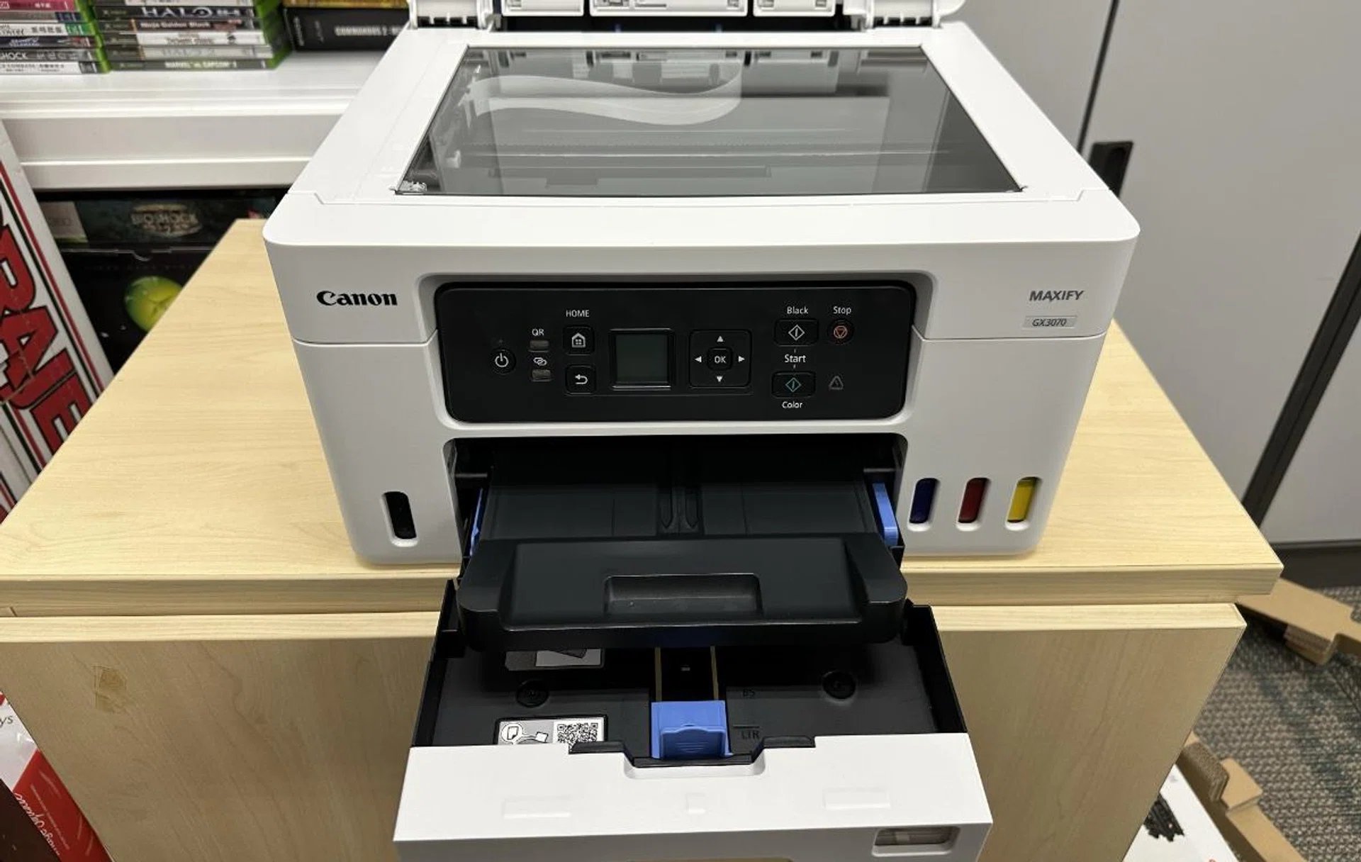 It has a paper cassette but lacks an ADF.