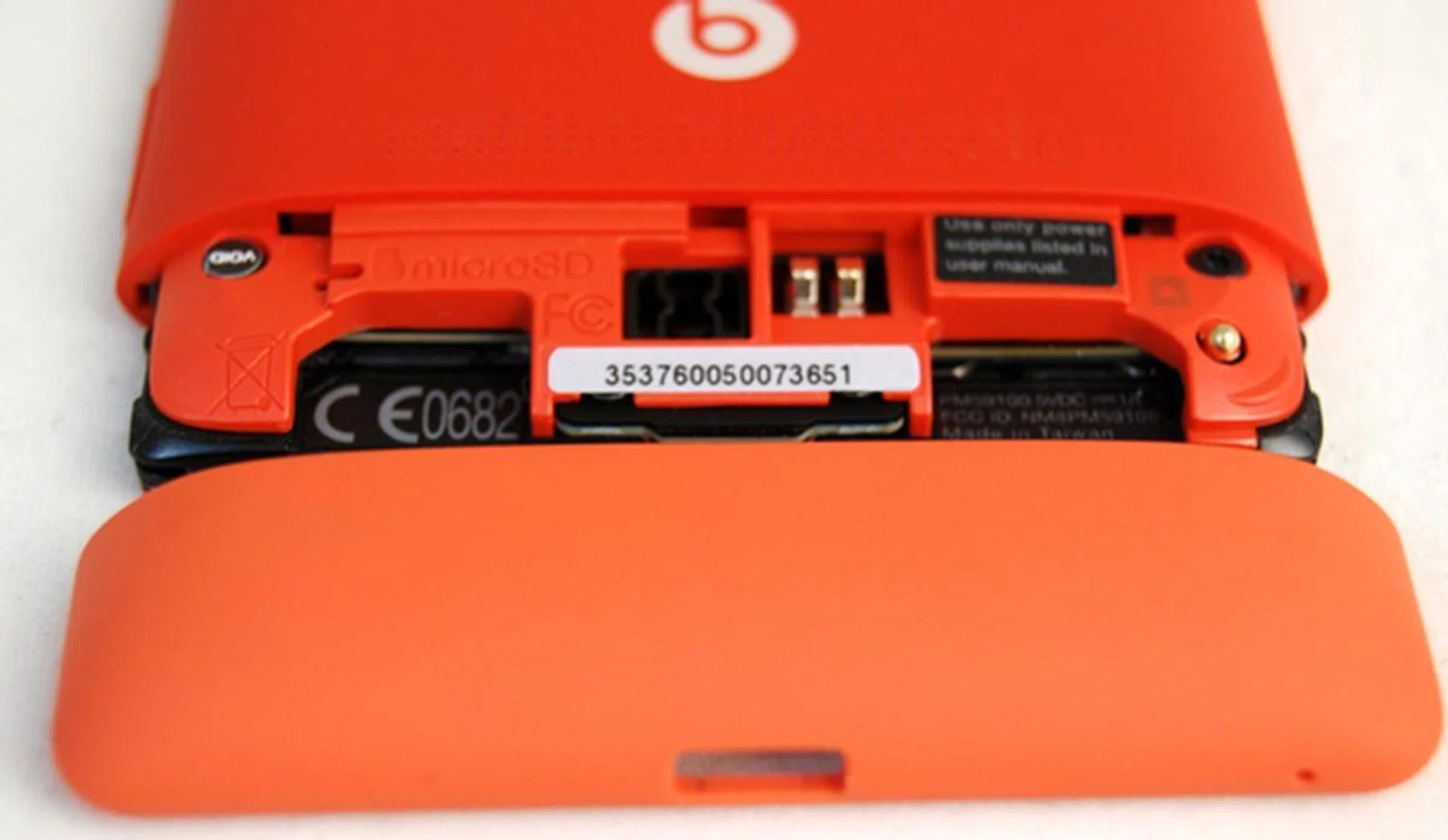 Remove the bottom section of the device to reveal the microSD card slot (left) and microSIM card slot (right).