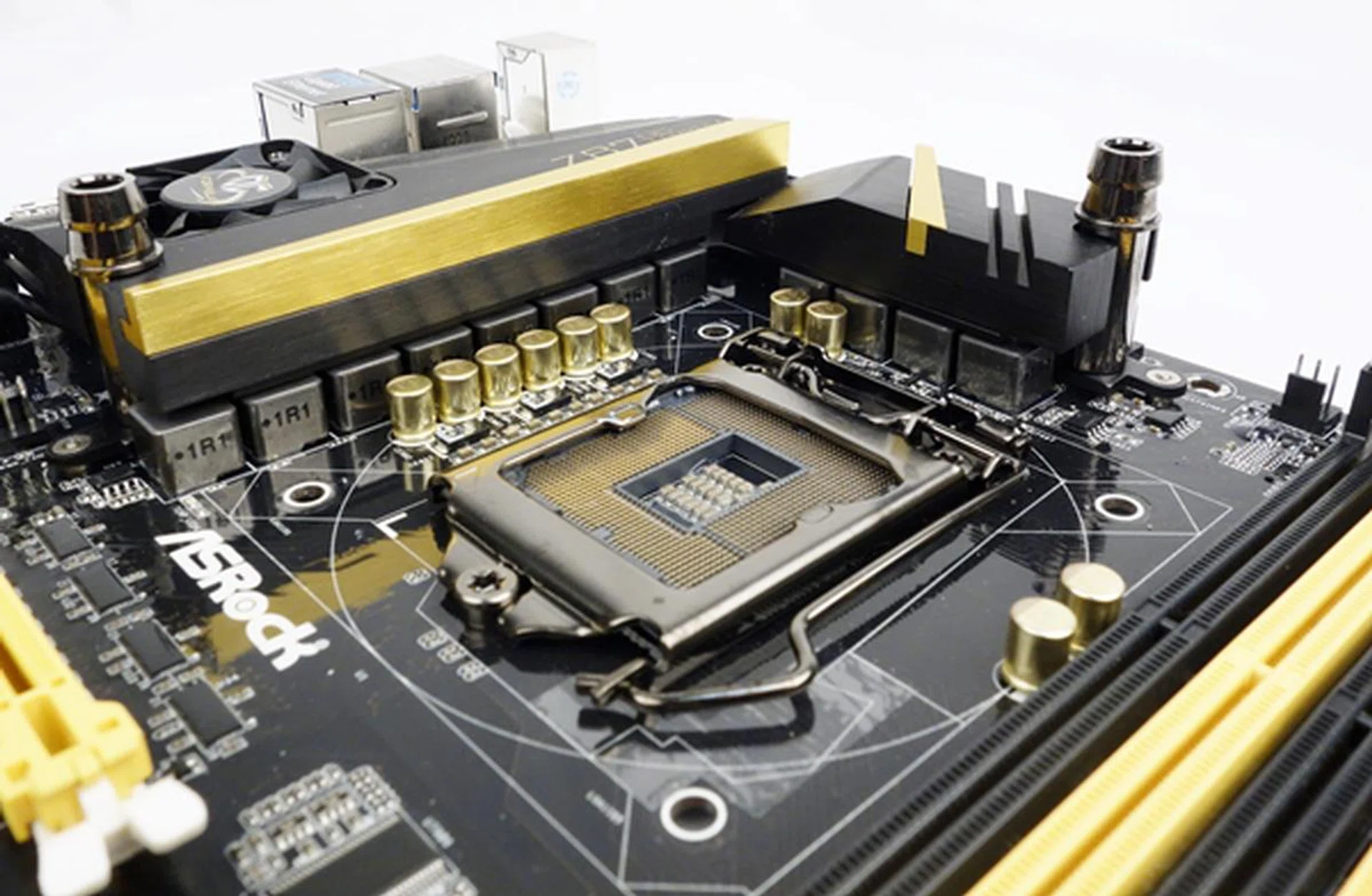 Seen here are some of the VRM components that make up the OC Formula Power Kit system. We can also see the barb fittings, so that a liquid cooling system can be attached to the VRM heatsinks for the additional cooling.