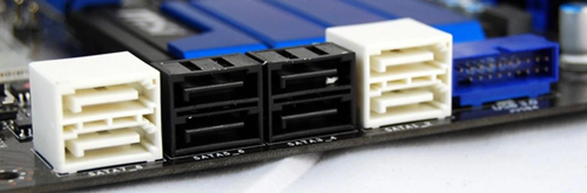 There are a total of eight SATA connectors - they are divided into two Intel 6Gbps ones (two rightmost connectors in white), four Intel 3Gbps connectors (black ones), and two 6Gbps connectors from the ASMedia AMS1061 controller (two leftmost ones, also in white). On a side note, this photo also shows you an internal USB 3.0 connector (to the right of the SATA ports) that is driven by the Intel Z77 chipset.