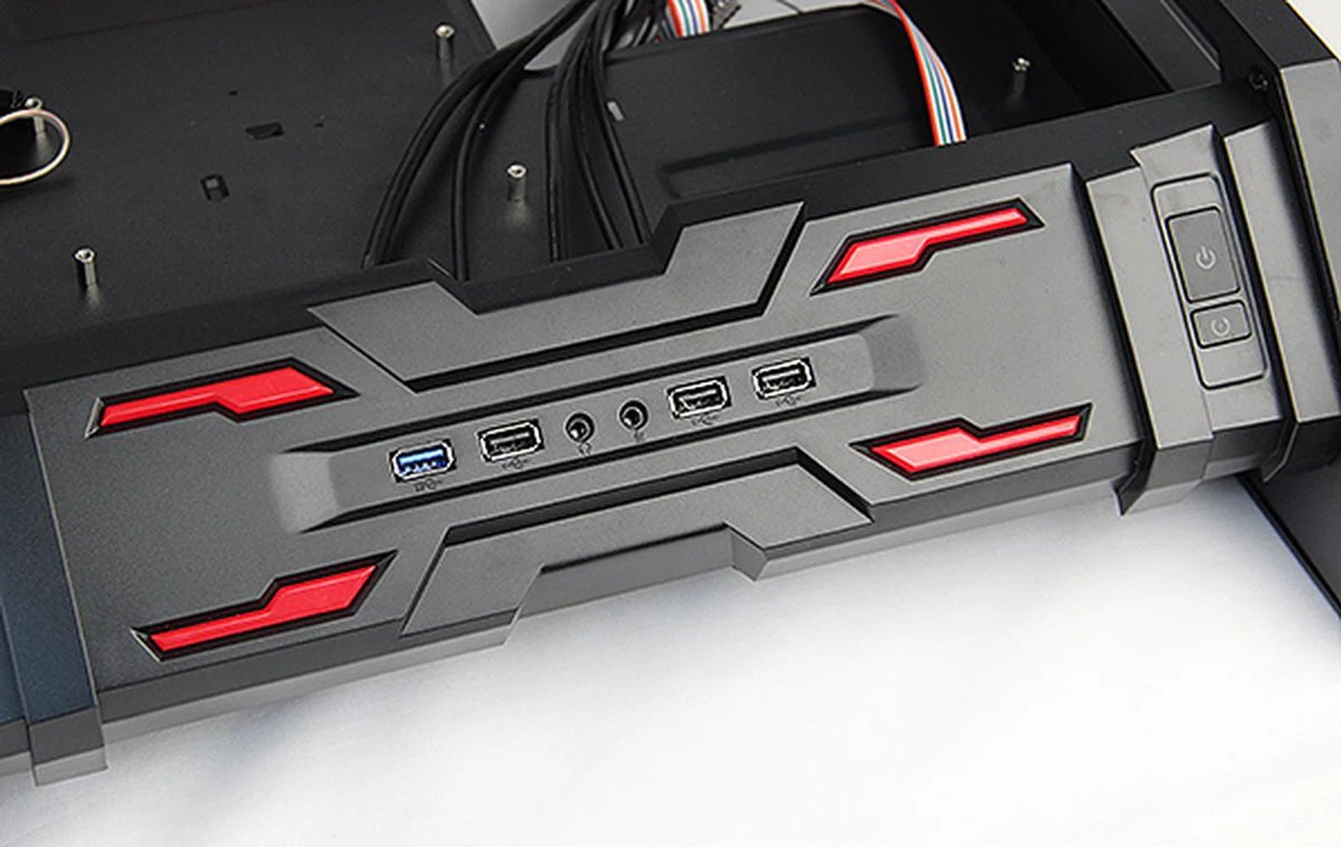 The front panel features red accents denoted an "X", and there's a single USB 3.0 port, three USB 2.0 ports, headphones and microphone jack. To the right are the power and reset buttons.