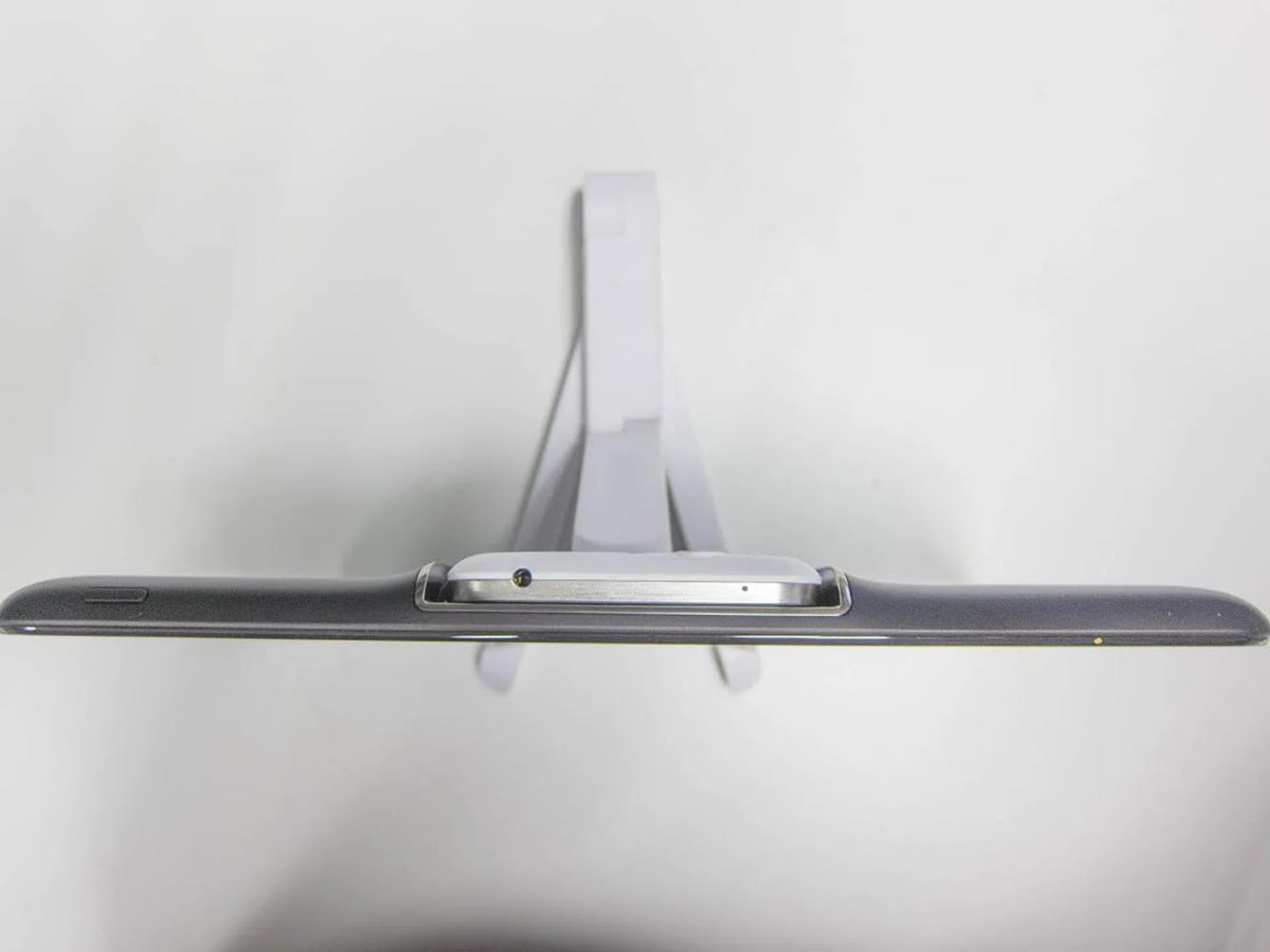 The docking station has a prominent bulge where the phone is docked.