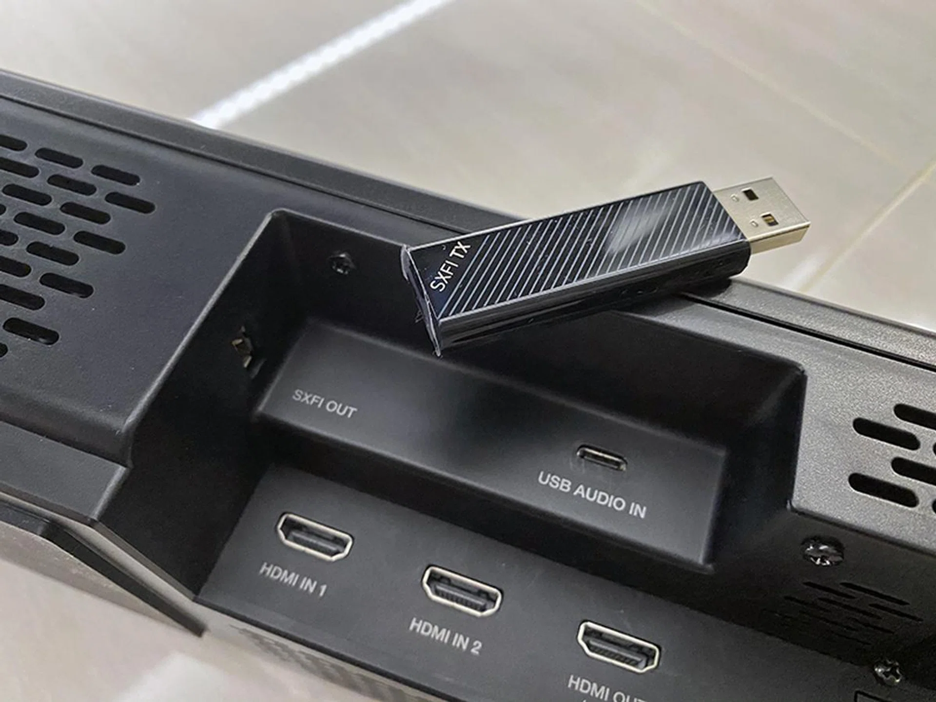 The SXFI Carrier comes with a good number of ports, including an SXFI out port, but they can be difficult to reach. Best to get the cabling right during setup and have it out of sigh and out of mind.