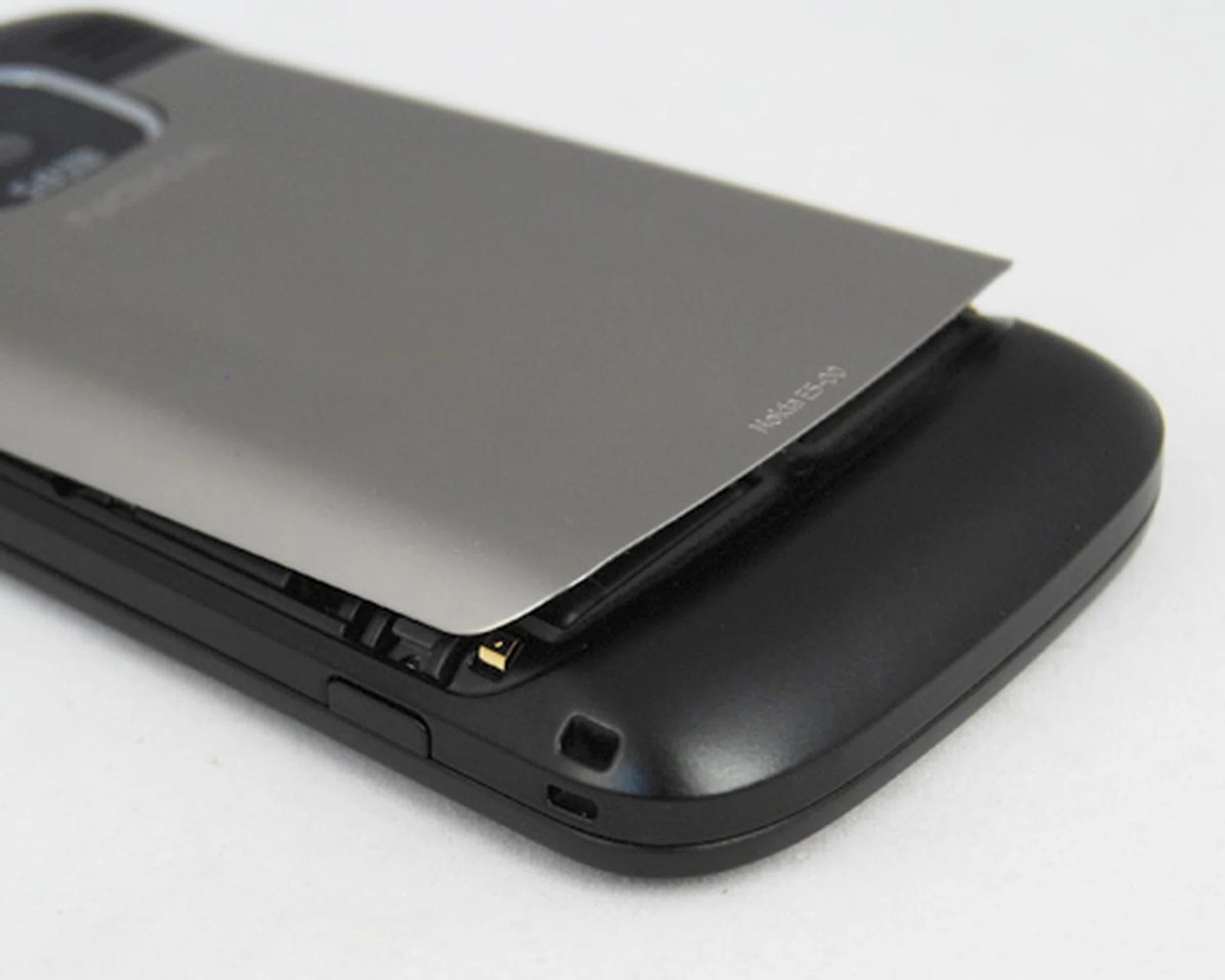 You'll need to press the catches here (and on the other side) to release the backing and access the battery and microSD cards underneath.