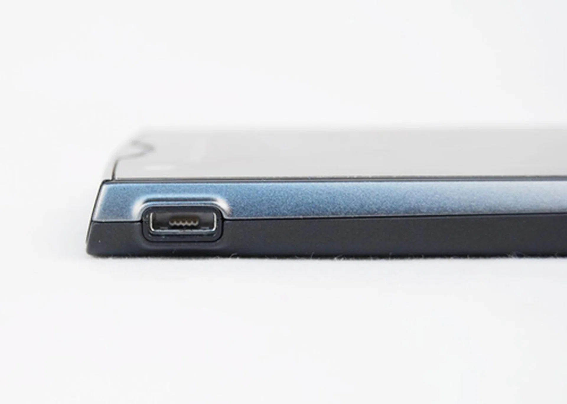 A bare-bodied USB port sits on the top left side of the phone.