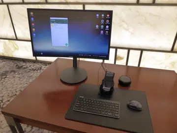 A complete Samsung DeX setup with a Galaxy S8 powering an Android desktop setting with monitor, keyboard and mouse.