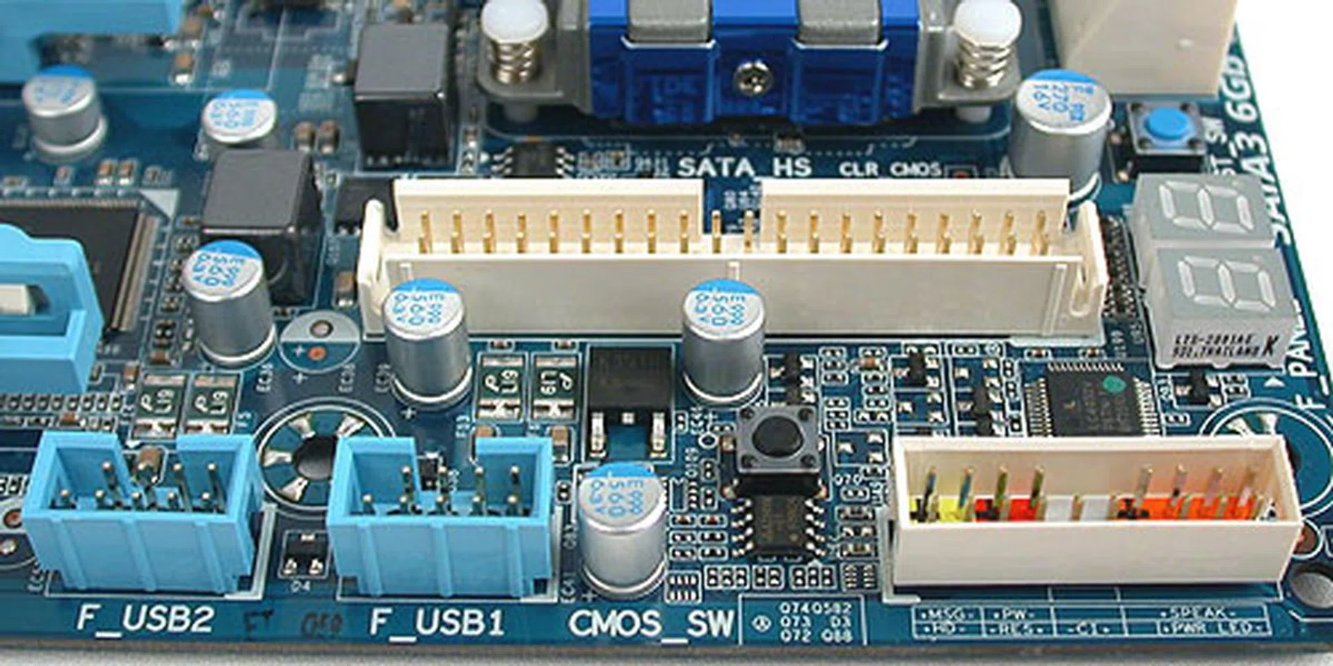 The IDE connector, USB 2.0 headers and the status LED surround front panel header. Almost hidden here is the black Clear CMOS button. 