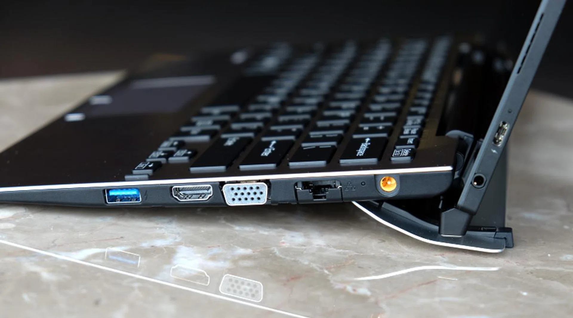 The keyboard houses a ton of ports. Here on the right is a USB-A (USB 3.0) port, an HDMI port, a VGA port, a Gigabit Ethernet jack, and power jack. Note also the USB-C (USB 3.1 Gen 1) port on the tablet itself.
