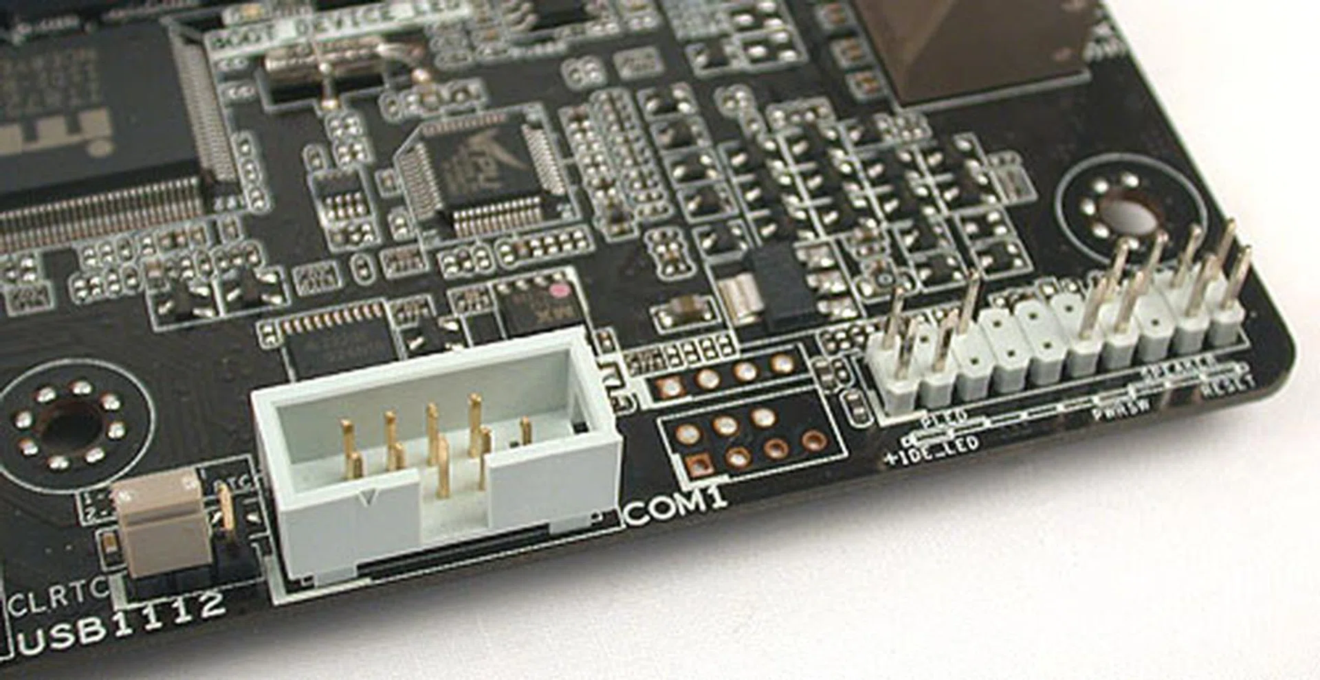 Another sign that the Sabertooth is not ASUS' top board in this category is the lack of onboard power and reset buttons. Instead, you'll find the usual front panel connectors and an old-school jumper to reset the BIOS. 