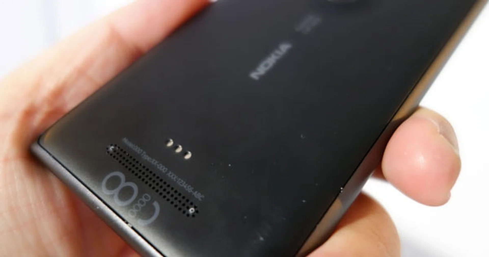 Bottom rear: The three metal dots are the contact points for the wireless-charging snap-on case; sold separately. Below that is the Lumia 925's speaker.