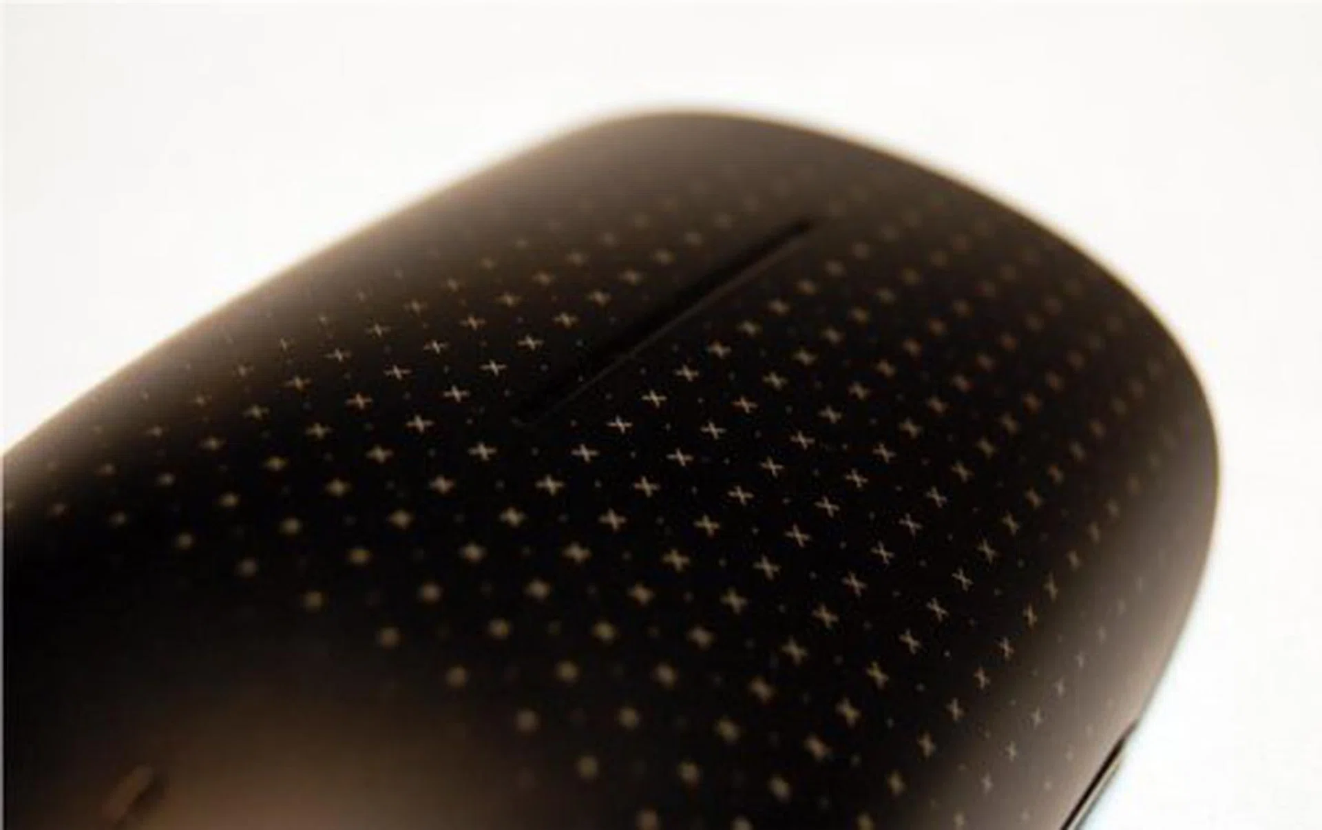 The pattern you see on the mouse is made by laser etching. It mimics the capacitive layer beneath. While it breaks the monotony of the device, we found it also provides slight guidance to your fingers when accessing the touch controls.
