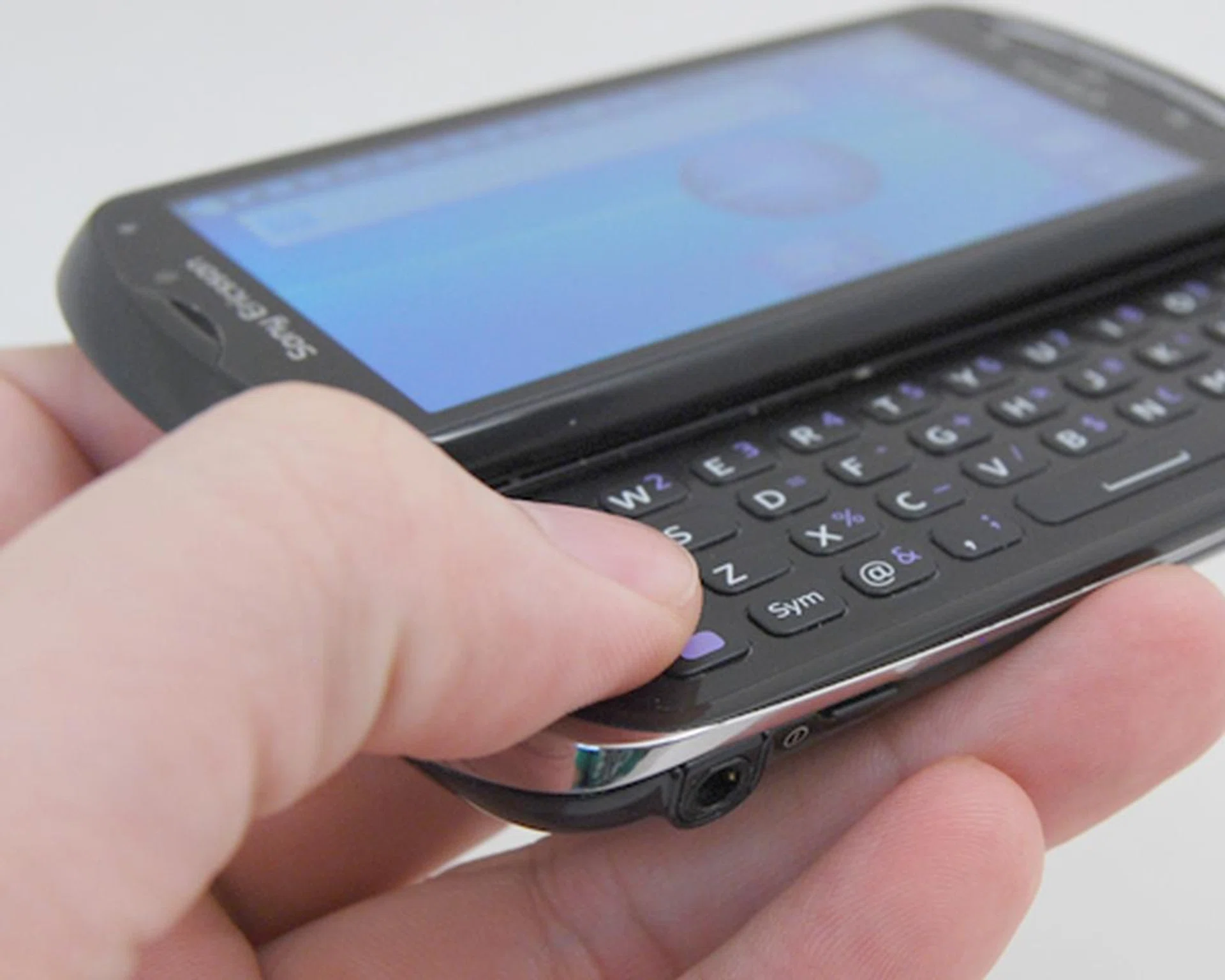 The physical QWERTY keyboard creates more screen real estate, but the downside is that it's stiff and thus slows down typing (slightly).