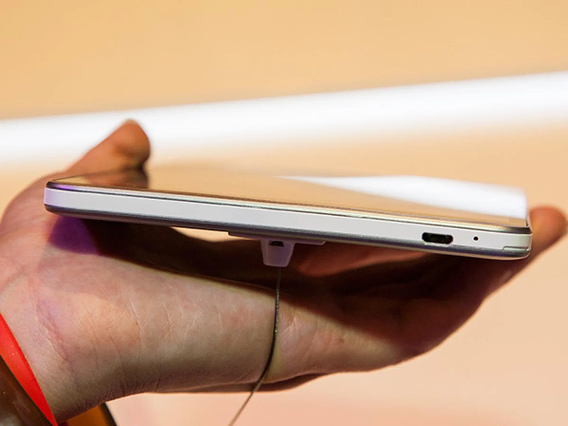 The USB port is located on the bottom side of the tablet.