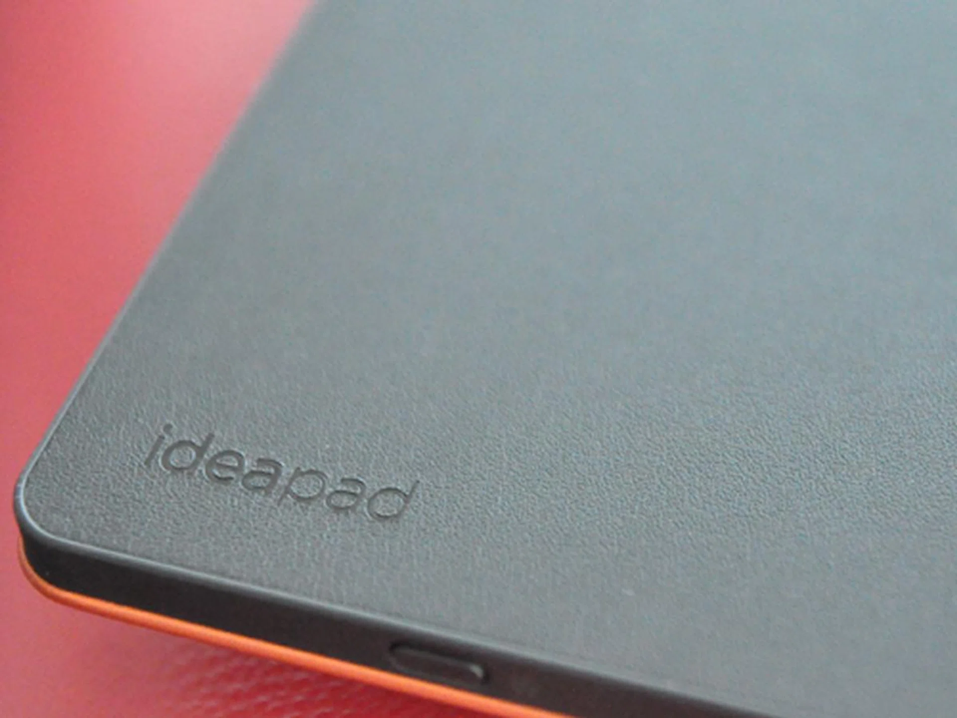 The palmrest is covered in a rubbery or leathery material that provides friction when the notebook is in stand mode. However, it may also pick up dirt and hair, depending on where you put it down. 