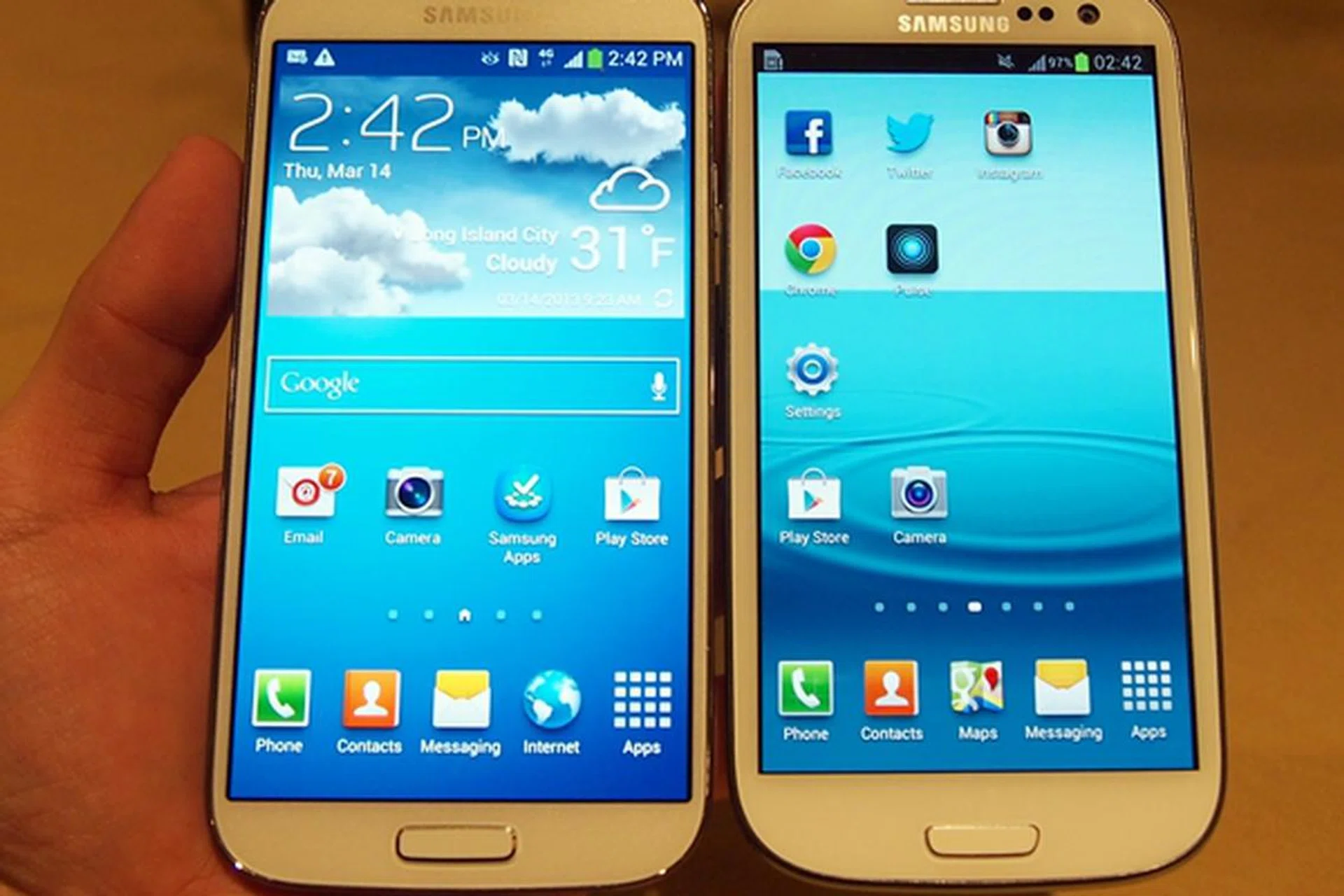 If not for the different default wallpapers, the placement of sensors and the slightly redesigned home button, it is nearly impossible to tell which is the Samsung Galaxy S4. <br> FYI, the phone on the left is the Galaxy S4.
