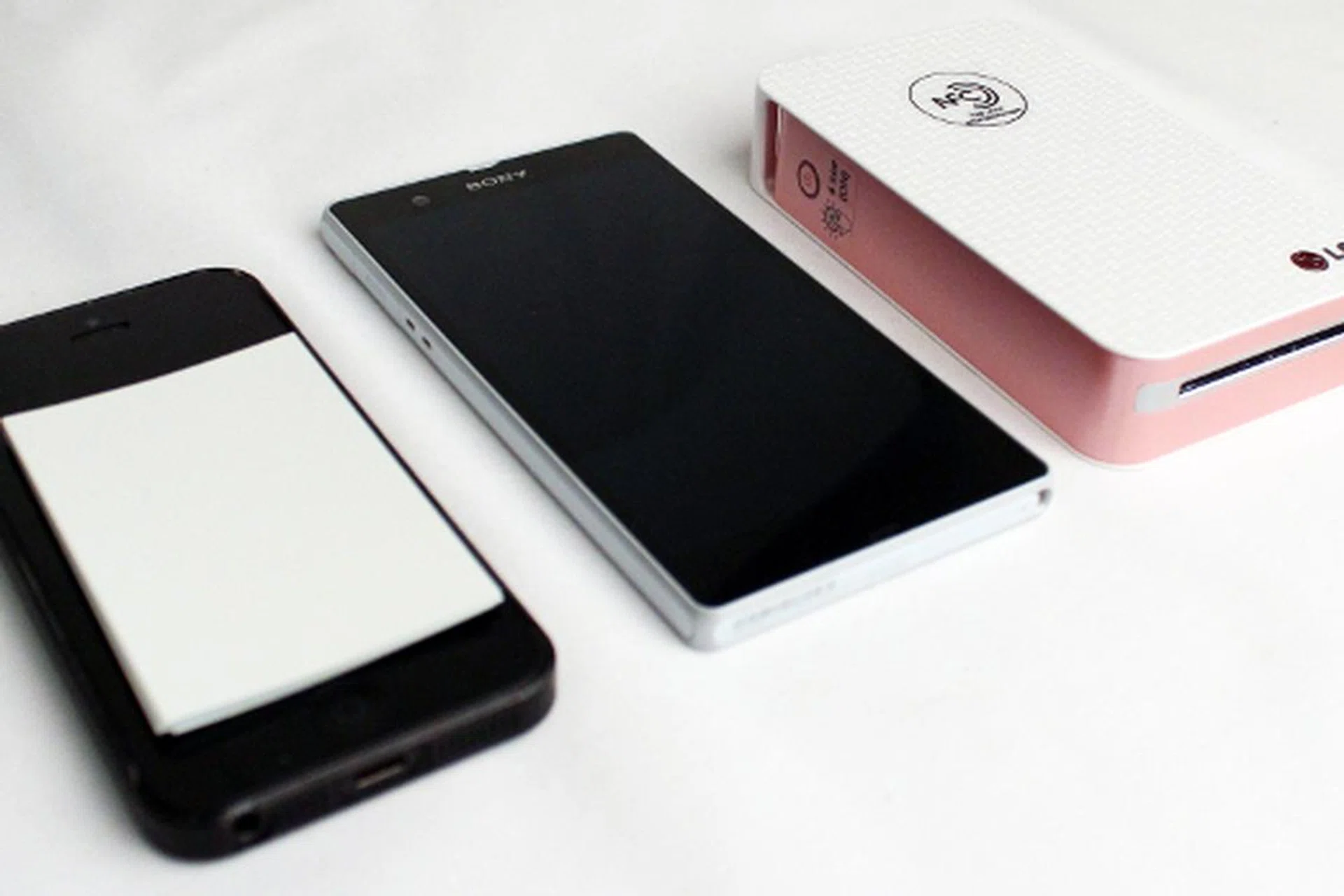 Pictured here (from left to right) is the iPhone 5, Sony Xperia Z and the LG Pocket Photo. The Zink paper is also placed on top of the iPhone to give you a reference on how large your prints will be.  