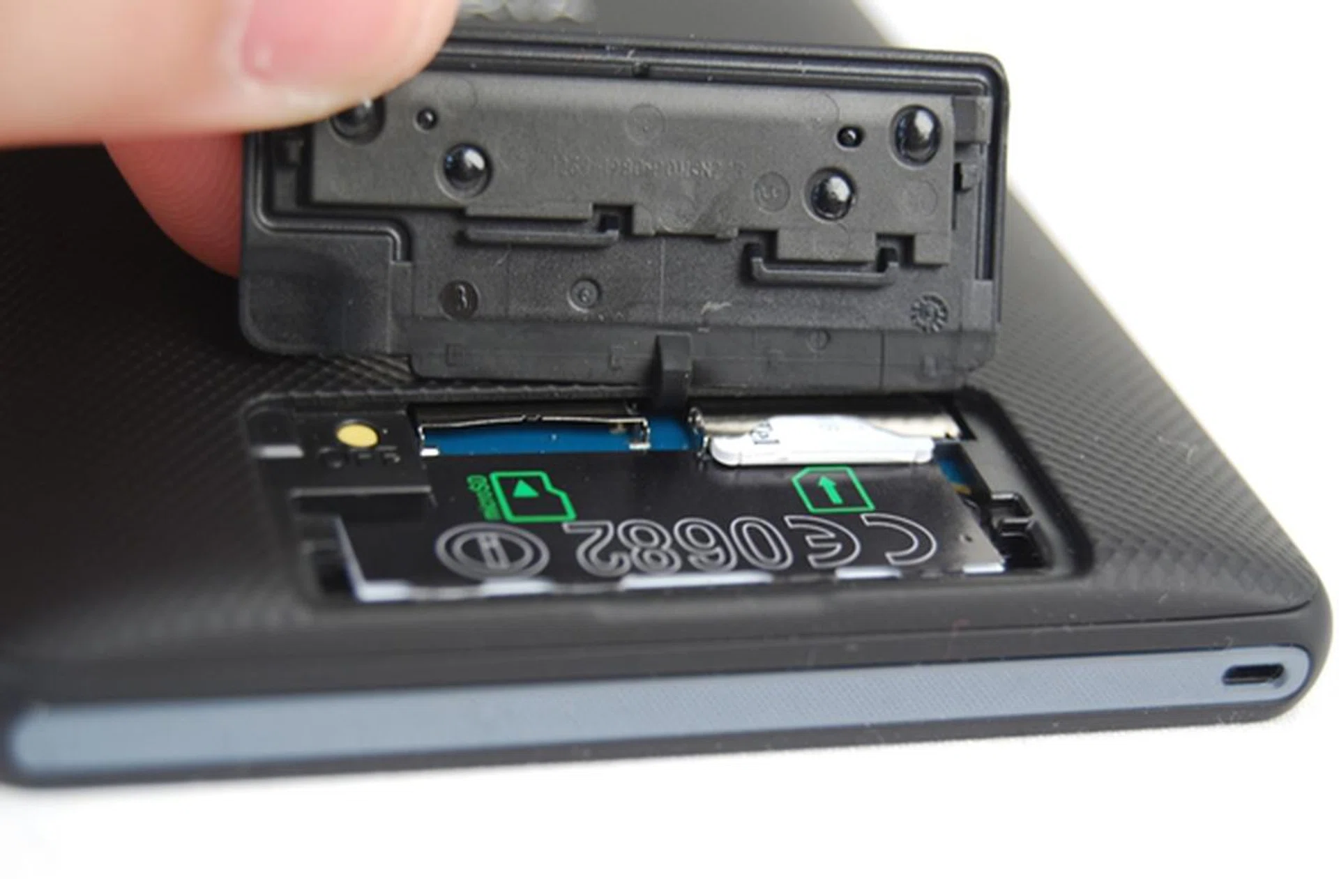 The plastic flap is easy to remove, but we wonder if Sony could do away with this and integrate the card slots at the side of the Xperia ZL.