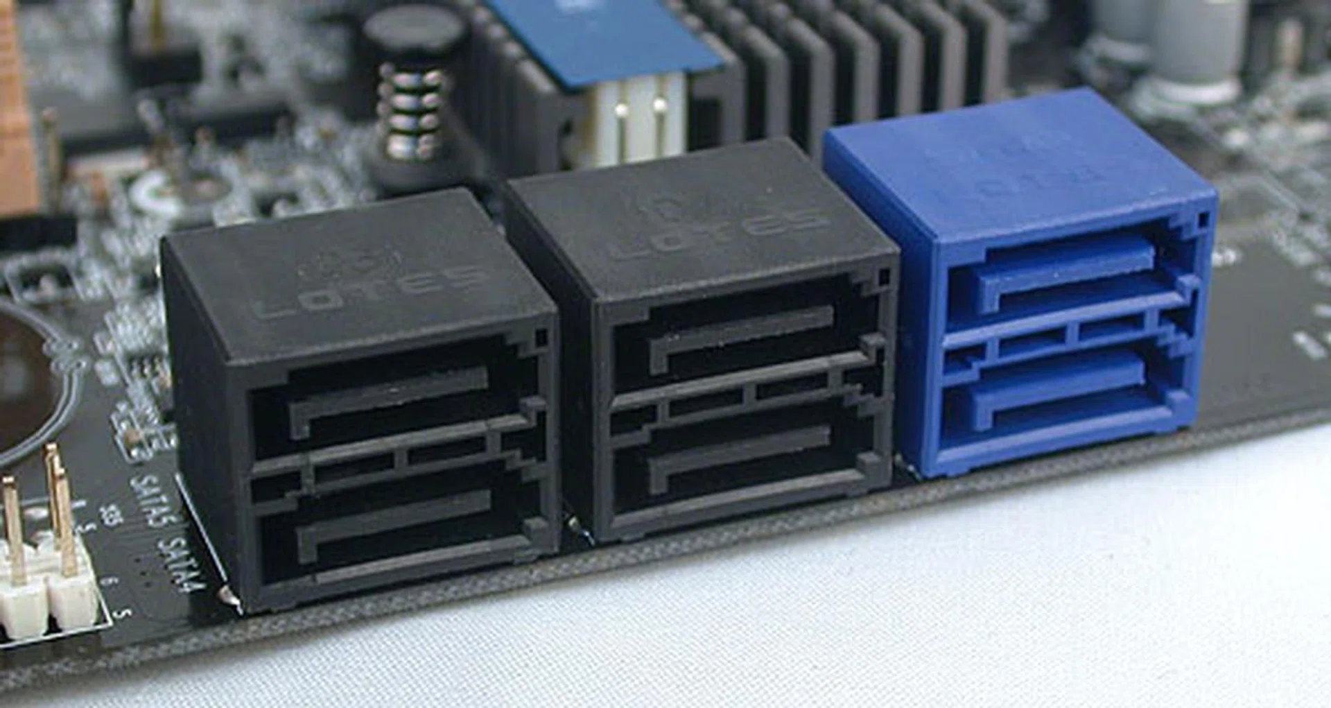 The four black ports are SATA 3Gbps versions while the blue ones are SATA 6Gbps. All located at the edge and out of the way.