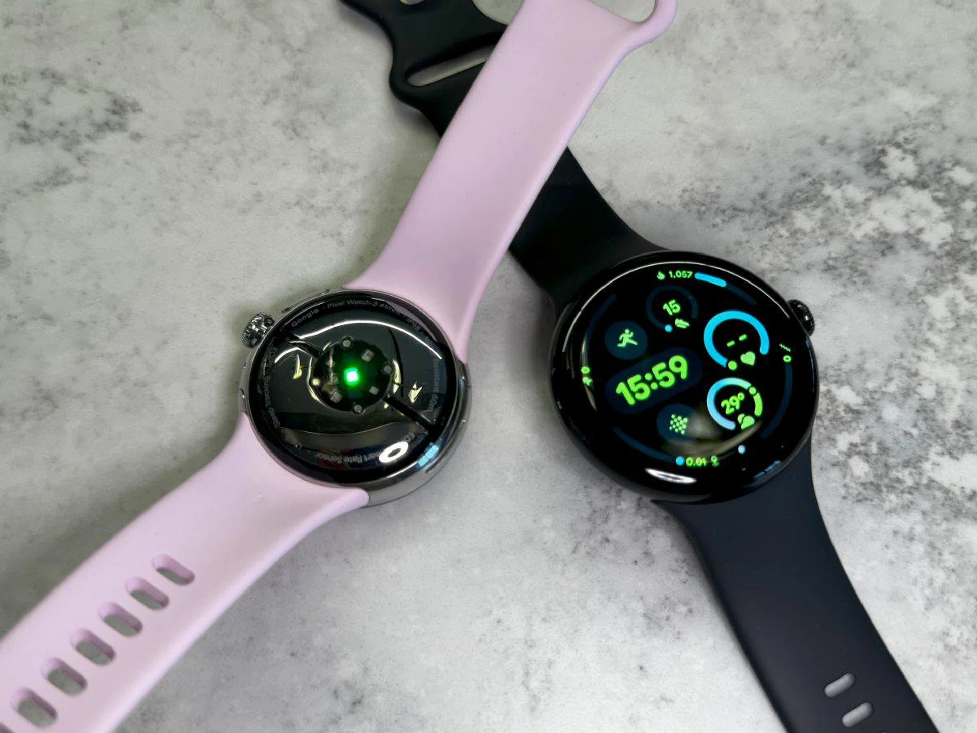 Google Pixel Watch 3 45mm (black face up), 41mm (pink sensor side up). Photo: HWZ