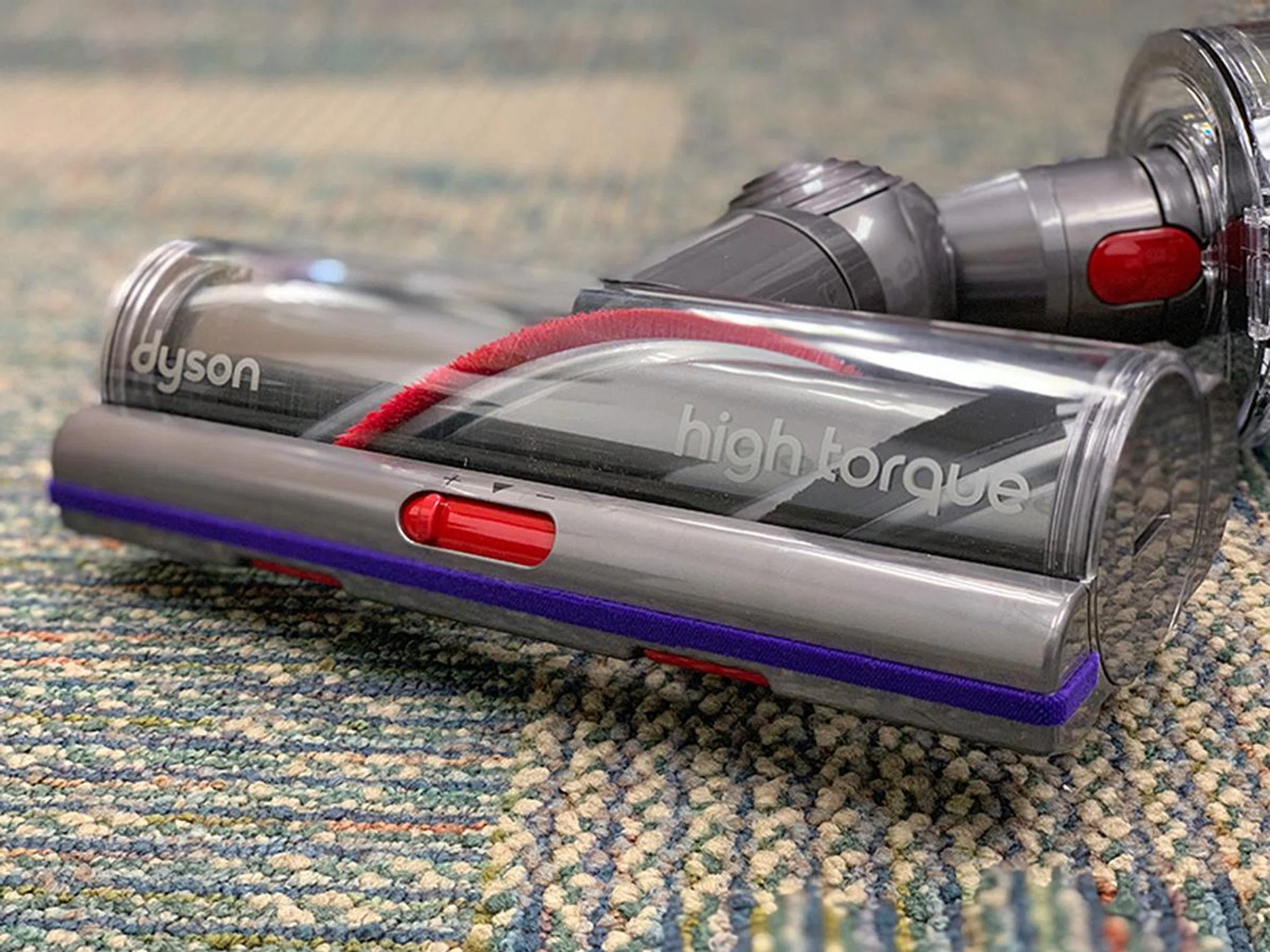 The red slider on the High Torque head is for opening and closing two tiny gates at the bottom of the head. Close the gates for more suction, open them to pick up bigger debris.
