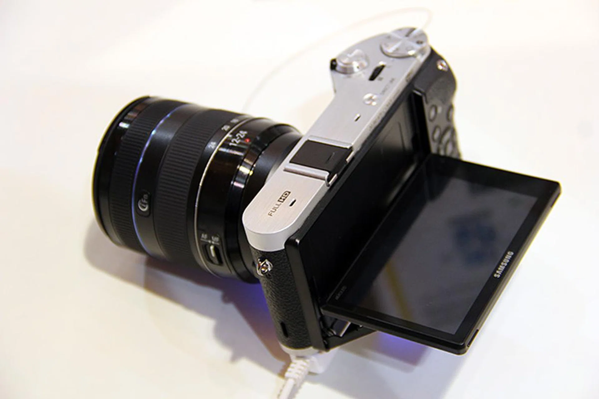 The NX300's screen tilts, but only up and down, not to the side.