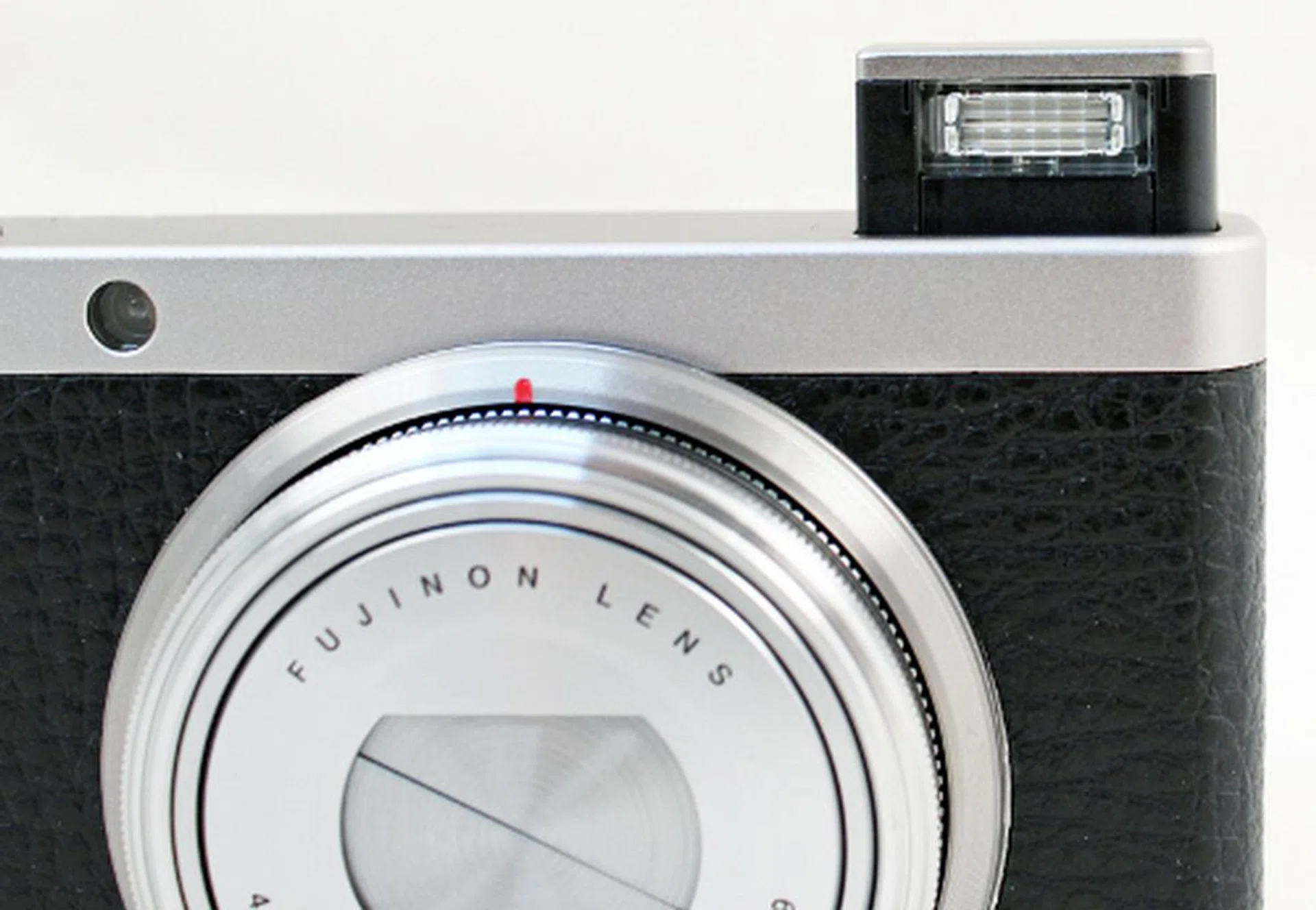 The flash isn't motorized, so you will have to pop it manually by sliding the switch behind it. 